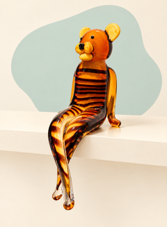 Seated amber stripe glass bear sculpture — angle view