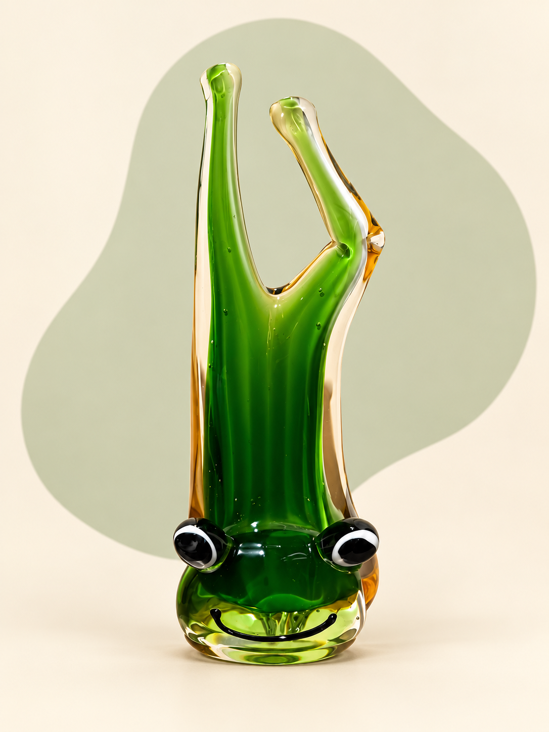 Green and amber glass frog sculpture — side view