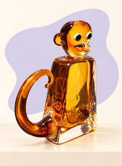 Amber glass monkey sculpture angle view